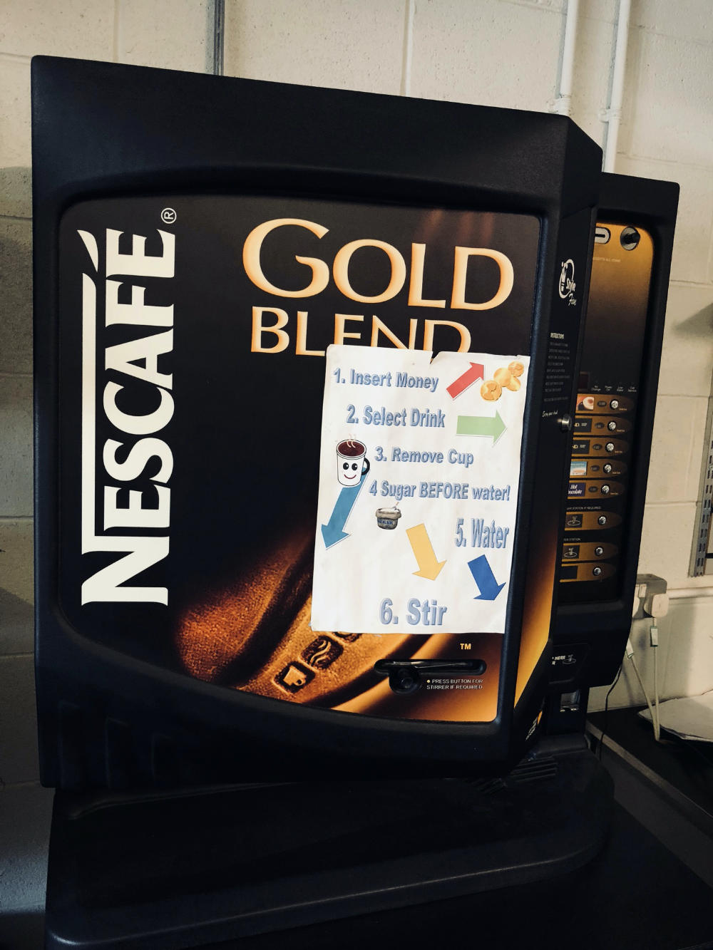 Coffee machine with garish instruction taped on